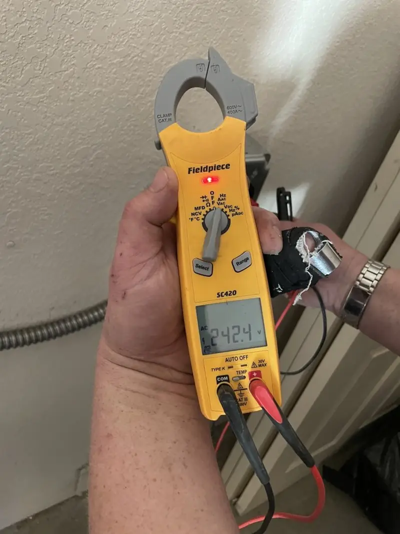 Voltage testing with clamp meter during Outlet Installation in Attica